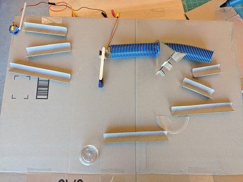Plan out your marble run on a flat piece of cardboard first