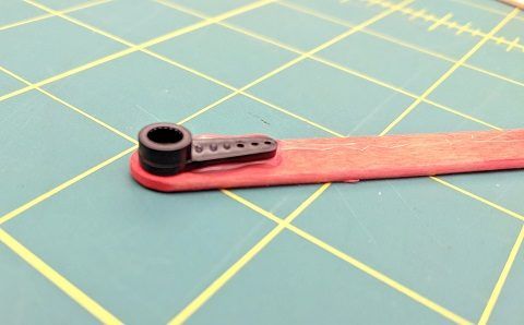 Glue servo horn to one end of the popsicle stick