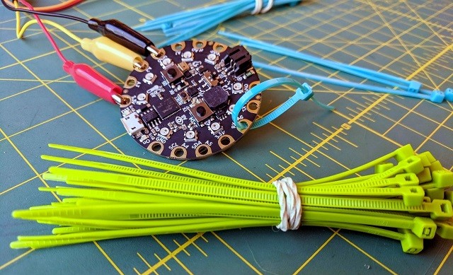 Adafruit Circuit Playground Express shown with a bundle of zip ties