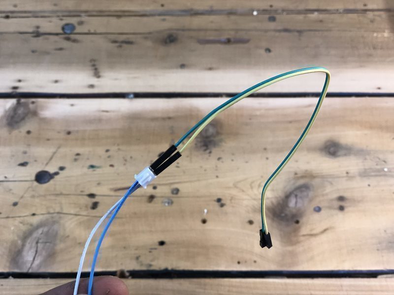 A JST connector with 2 female jumper wires attached