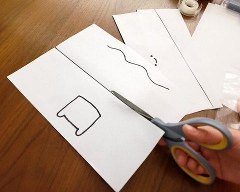 Cutting paper in half with scissors