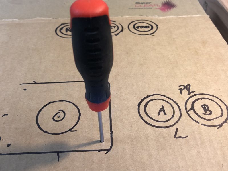 A screwdriver used as a drill for the joystick holes